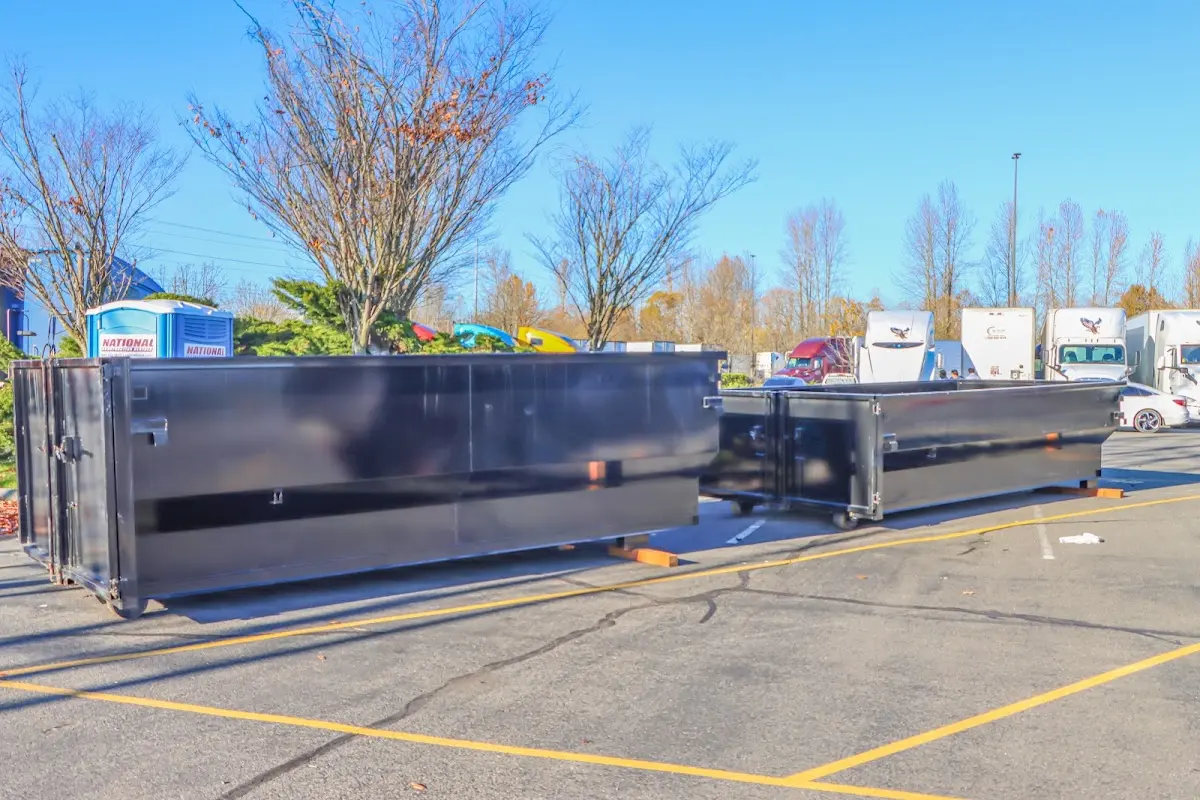 Professional dumpster rental service with roll-off container on residential driveway in Middlesborough
